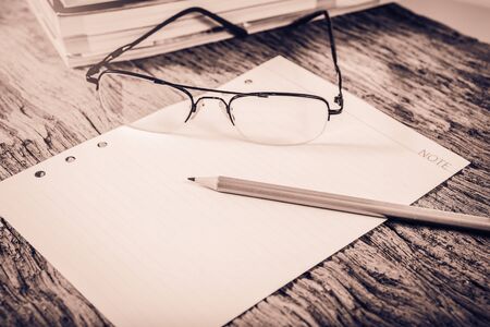 office supplies on old wood table ; vintage process style