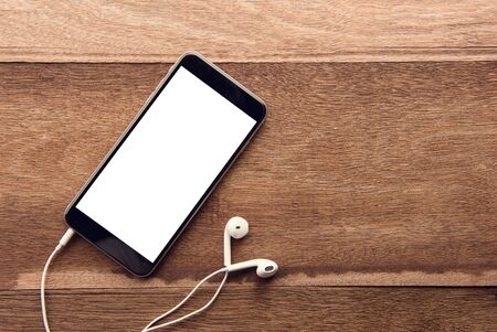 Smartphone with white screen On Wooden Table With Copyspace