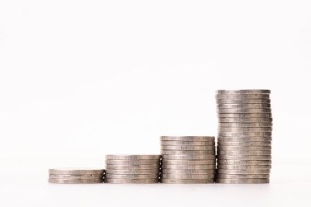 money coins arranged as a graph on white background