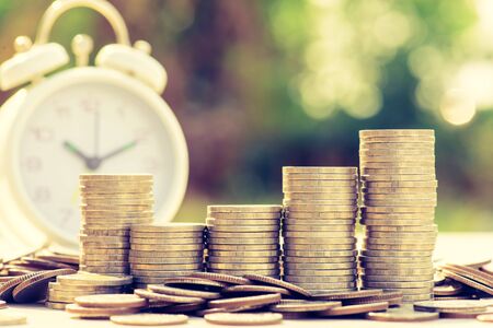 Finance and Money concept, Money coin stack growing graph with sunlight,investmentの写真素材