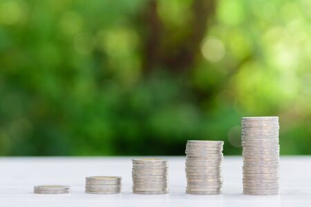 Business Finance and Money concept, Money coin stack growing graph with green bokeh...