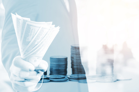 Businessman with money in hand, US dollar (USD) bills - investment, success and profitable business conceptsの写真素材