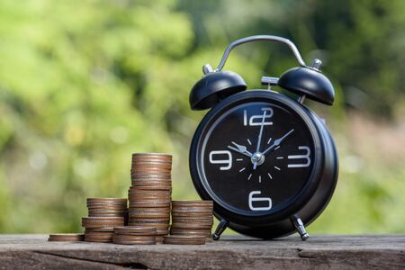 wintage alarm clock money coin stack growing business,Finance and Money concept,Hope of investor conceptの写真素材