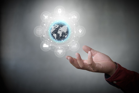 Human hand holding our planet earth glowing with tech icon flow connection concept.