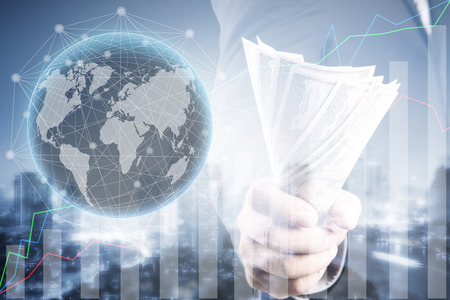 Double exposure of Businessman with money in hand and financial graph , US dollar (USD) bills - investment, success and profitable business concepts,Business Trading concept Business Trading concept,world connectionの写真素材