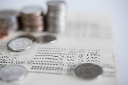 close up of book bank with blur rows coins for finance and banking conceptの写真素材