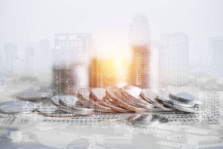 Double exposure of coins and city background for finance and banking conceptの写真素材