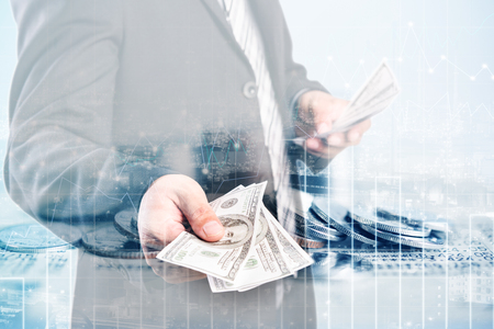 Double exposure of coins and city background for finance and banking conceptの写真素材