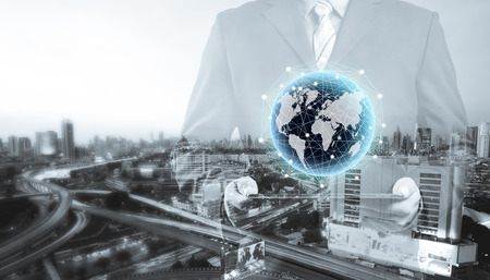 double exposure of businessman using tablet with blur city night and network connection conceptの写真素材