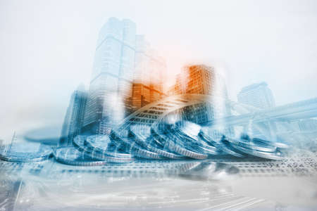 Double exposure of coins and city background for finance and banking conceptの写真素材