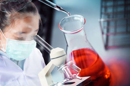 scientist with microscope, medical research and development conceptの写真素材