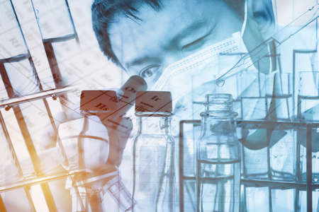 Double exposure of Laboratory pipette with drop of liquid over glass test tubes for an experiment in a science research lab , Laboratory research conceptの写真素材