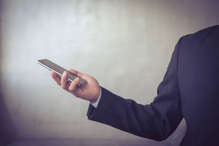 business man hand holding smart phoneの写真素材
