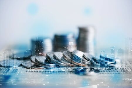 Double exposure of coins and city background for finance and banking conceptの写真素材