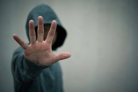 Portrait of a casual man showing stop signの写真素材