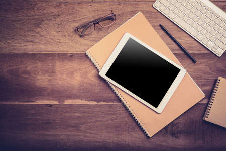 White Tablet With Blank Screen On Wooden Desk With Stationery Objects , Top Viewの写真素材