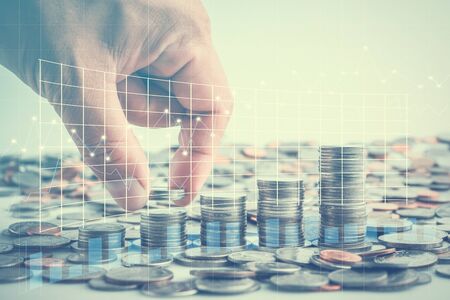 Male hand putting coins with money stack step growing growth saving money with business graph, Concept finance business investmentの写真素材