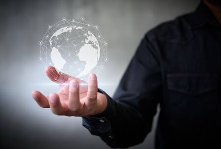 Businessman with virtual Earth map point with network connection on hand, international meaningの写真素材
