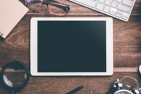 White Tablet With Blank Screen On Wooden Desk With Stationery Objects , Top Viewの写真素材