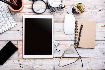 White Tablet With Blank Screen On Wooden Desk With Stationery Objects , Top Viewの写真素材