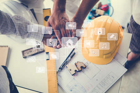 Meeting the team of engineers working on a construction smart home project at the table. top viewの写真素材