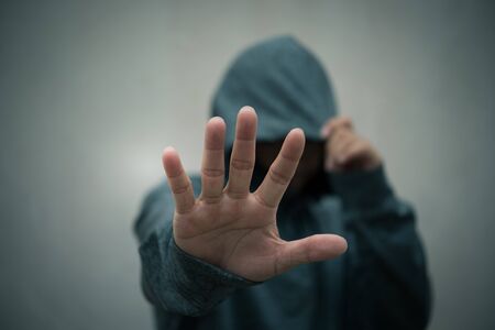 Portrait of a casual man showing stop signの写真素材