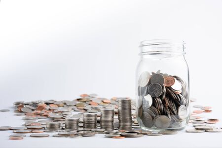 Coins in jar with money stack step growing growth saving money. Concept finance business investmentの写真素材