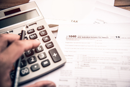 Pencil with tax form 1040 and calculator,Tax time conceptの写真素材