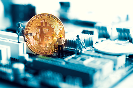 golden coin symbol bitcoin on mother board Blockchain , cryptocurrencies , bitcoin and distributed...