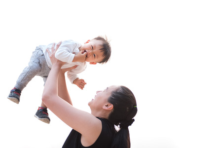 Mom is playing with cute baby on white backgroundの写真素材