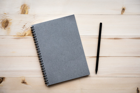 Notebook Blank notebook with pencil on wooden background.の写真素材