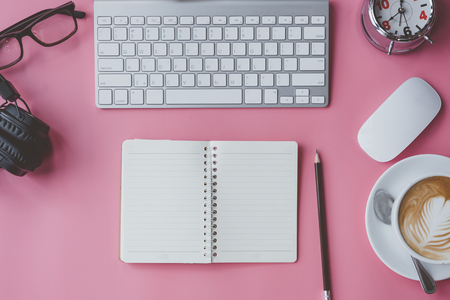 business, education concept. Office supplies, blank screen notebook eyeglasses on a pink table.top view.の写真素材