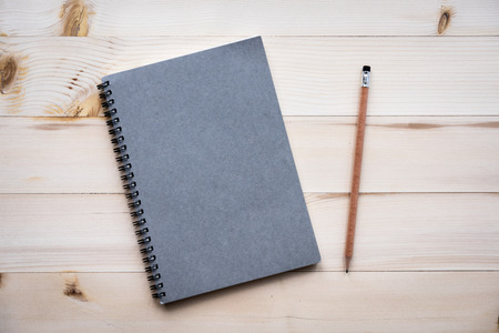 Notebook Blank notebook with pencil on wooden background.の写真素材
