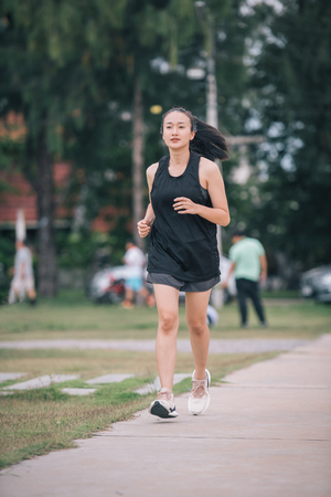 beautiful Asian girls Jogging in the park,Healthy Conceptの写真素材