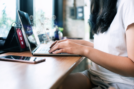 woman hand using laptop and cup of coffee her working on laptop. payments online shopping and icon customer network connection on screen.の写真素材
