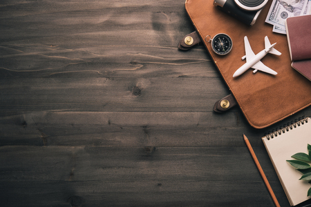 Travel accessories and costume on wooden floor,Travel concept.coppy space for text or design.の写真素材