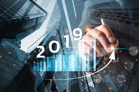 2019 New year planning business and financial concept.Man's hand writing on virtual screen with business graph.digital marketing and payment.の写真素材