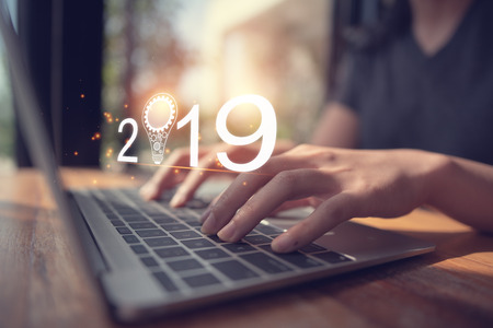 Businesswoman using laptop, searching web, browsing information, having workplace at office / Business new year 2019 conceptの写真素材