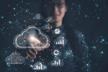 Big data analytics and business intelligence concept with chart and graph icons on a digital screen interface and a businesswoman in backgroundの写真素材