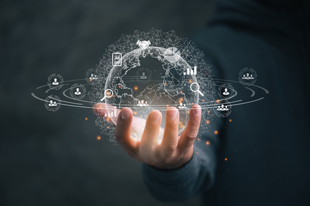 businessman houlding Global network connection. Big data analytics and business intelligence concept. World map point and line composition concept of global business.の写真素材
