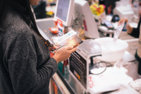 mobile payment ,Transaction online, payment , online shopping , cashless technology concept.woman using smart phone for pay.の写真素材