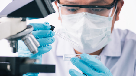 scientist with equipment and science experiments ,laboratory glassware containing chemical liquid for design or decorate science or other your content and selective focusの写真素材