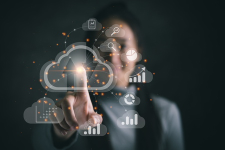 Big data analytics and business intelligence concept with chart and graph icons on a digital screen interface and a businesswoman in backgroundの写真素材