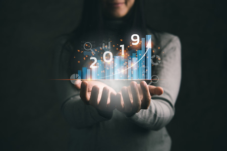 2019 New year planning business and financial concept.Businesswoman holding virtual screen of business graph.digital marketing and payment.の写真素材
