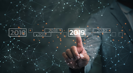 Businessman touching on virtual screen 2019. Business new year card concept, welcome year 2019 conceptの写真素材
