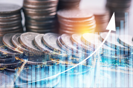 Double exposure of graph and rows of coins for finance and business conceptの写真素材