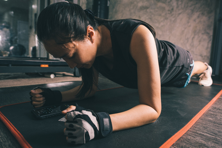 young attractive fitness woman exercise with machine in gym. Individual sport to fit muscles of body for healthy life conceptの写真素材