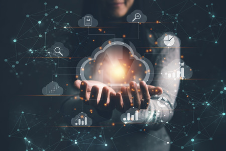 Big data analytics and business intelligence concept with chart and graph icons on a digital screen interface and a businesswoman in backgroundの写真素材