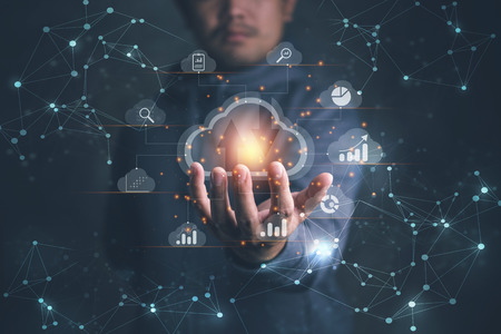 Big data analytics and business intelligence concept with chart and graph icons on a digital screen interface and a businessman in backgroundの写真素材