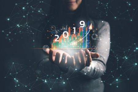 2019 New year planning business and financial concept.Businesswoman holding virtual screen of business graph.digital marketing and payment.の写真素材